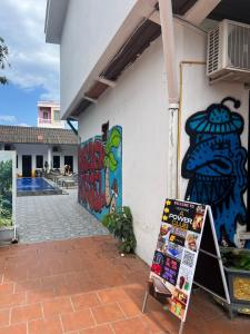 a building with graffiti on the side of it at Vientiane Apower Hostel & Club in Vientiane