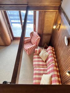 an overhead view of a room with two chairs and a couch at Casa Cristallo in Breuil-Cervinia