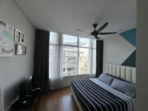 a bedroom with a bed and a ceiling fan at KLCC Private Bedroom in DUAL KEY Unit in Kuala Lumpur