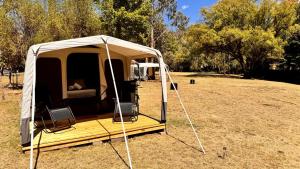a tent is set up in a field at Omeo Holiday Park in Omeo