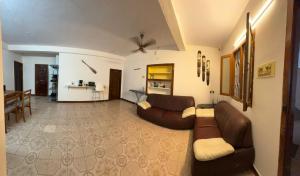 a living room with a brown couch and a table at Hostel Madras in Chennai