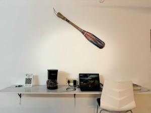 a table with a baseball bat hanging on a wall at Hostel Madras in Chennai