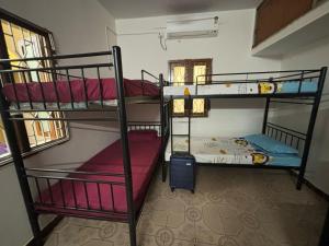 a room with three bunk beds in a room at Hostel Madras in Chennai