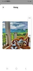 a room with a table with a view of a balcony at Mộc Nhiên Homstay Mai Chau in Hòa Bình +7 photos