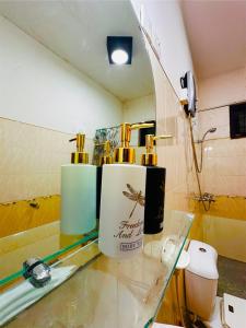 a bathroom with two bottles of alcohol on a glass counter at Greenmoret AgriTourism Villa in Bandarawela
