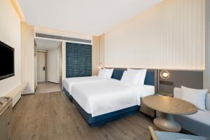 Postel nebo postele na pokoji v ubytování C&D Hotel Dongshan Zhangzhou