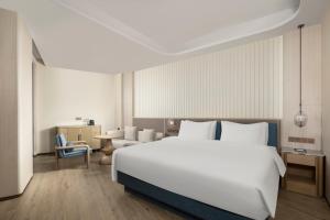 Postel nebo postele na pokoji v ubytování C&D Hotel Dongshan Zhangzhou