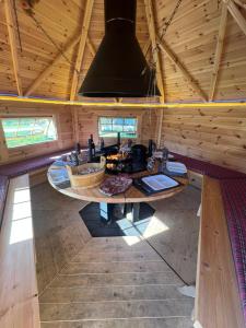 a large room with a table in a cabin at Domaine du Rosiere in Favières