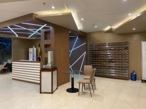 a lobby with a desk and a chair and a podium at 1517 Deluxe Room at Sunvida Tower in Cebu City +14 photos