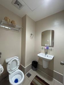a bathroom with a toilet and a sink at 1517 Deluxe Room at Sunvida Tower in Cebu City