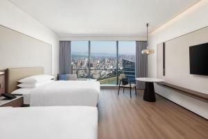 Voodi või voodid majutusasutuse Jieyang Marriott Hotel toas