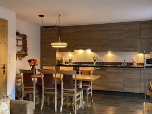 a kitchen with a table and chairs in a kitchen at Seppl's Holiday Home Comfortable holiday residence in Sautens