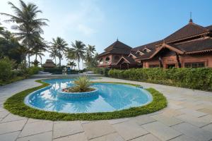 a swimming pool in the middle of a resort at Lakesong Resort in Kumarakom