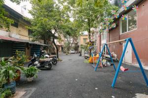 an empty street with a swing set on the side of a building at Train Street Lux Homestay in Hanoi +17 photos