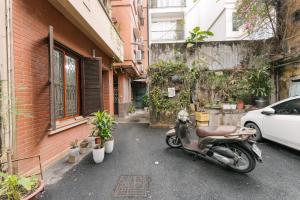 a motorcycle parked on the street next to a building at Train Street Lux Homestay in Hanoi