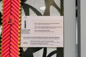 a sign in a door with red and yellow ropes at Train Street Lux Homestay in Hanoi