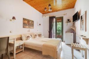 a bedroom with a bed and a table and chairs at Nontas Homes 34 in Kalamitsi