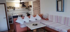 a living room with a couch and a table at House in Rodalquilar valley in Rodalquilar +14 photos