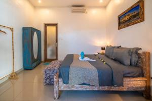 En eller flere senge i et værelse på Pondok Putri Bali