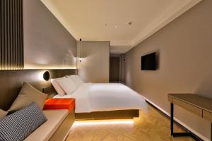 Voodi või voodid majutusasutuse Manji Yunfan Hotel Shenyang Zhongjie North Station Forbidden City Dashuaifu Branch toas