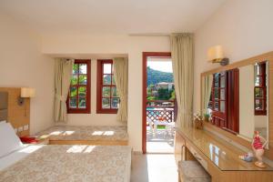 a bedroom with a bed and a large window at Alize Hotel Oludeniz - All Inclusive in Oludeniz +64 photos