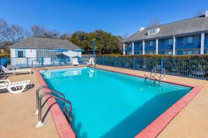 a large swimming pool in front of a building at Baymont by Wyndham Selma in Selma
