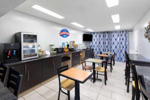 a dining room with tables and chairs in a restaurant at Baymont by Wyndham Selma in Selma