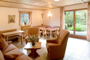 a living room with a table and chairs at Apartments Lettenmaier in Oberried