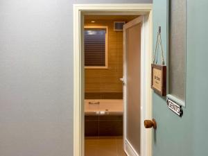 a bathroom with a sink and a bath tub at Pension B,B, Dylan - Vacation STAY 22450v in Otsu