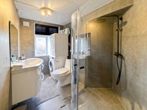 a bathroom with a toilet and a sink and a shower at Central BnB Apartment Nr6 Stavanger 4 Bedrooms in Stavanger +82 photos