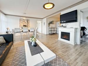 a living room with a couch and a fireplace at Central BnB Apartment Nr6 Stavanger 4 Bedrooms in Stavanger