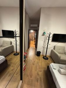 a room with a bed and a living room at Oda Garden Boutique Hotel in Tirana