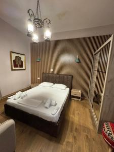 a bedroom with a bed and a chandelier at Oda Garden Boutique Hotel in Tirana +13 photos