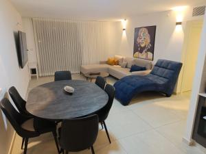 a living room with a table and a couch at סי סייד אילת סוויטה משפחתית 2 חדרים עם מרפסת ונוף לים in Eilat