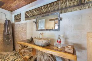 a bathroom with a sink and a mirror at Megalan Villa Balangan in Badung +26 photos