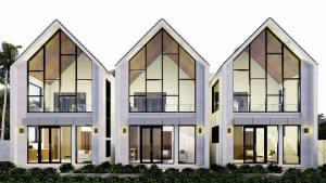a three story building with large glass windows at Villa Tres Adam in Canggu