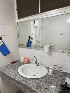 a bathroom counter with a sink and a mirror at 木子李 in Jomtien Beach