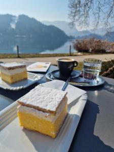 a piece of cake on a table with a cup of coffee at Slovenian House Vida in Bled