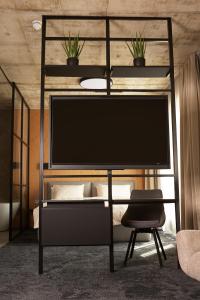 a black bunk bed with a tv on top of it at Air Hotel in Karmėlava
