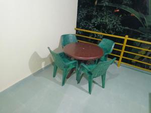 a table and chairs sitting on a balcony at Swarang homestye in Nandgaon