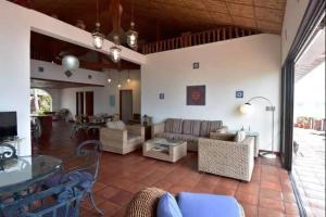 a living room with a couch and a table at Kasbah Remo Villa Puerto Galera in Puerto Galera +16 photos