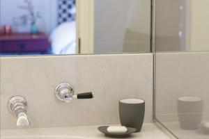 a bathroom with a sink and a mirror at Old Parsonage Hotel in Oxford