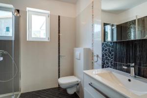 a bathroom with a toilet and a sink and a shower at Apartment Mirna in Nerezine