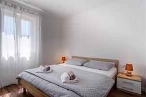 a bedroom with a bed with towels on it at Apartment Mirna in Nerezine