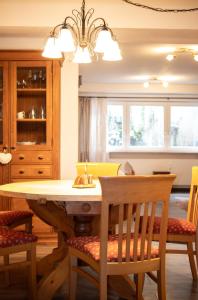 a dining room with a wooden table and chairs at meywohnen Prien am Chiemsee in Prien am Chiemsee