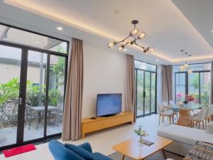 a living room with a couch and a tv at Wyndham Cam Ranh Villa 1412 in Cam Lâm