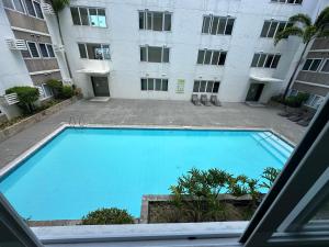 a large swimming pool in front of a building at Stanford Suites 1 in Silang