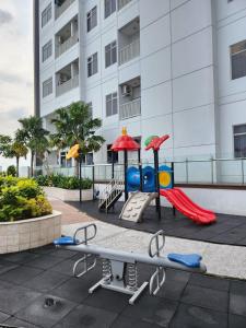 a playground in front of a building at Cozy Studio Apartement South Surabaya in Surabaya