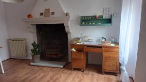 a kitchen with a wooden desk and a fireplace at Artemilland B&B in Burzanella +32 photos