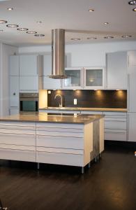 a large kitchen with white cabinets and a sink at meywohnen Prien am Chiemsee in Prien am Chiemsee +8 photos